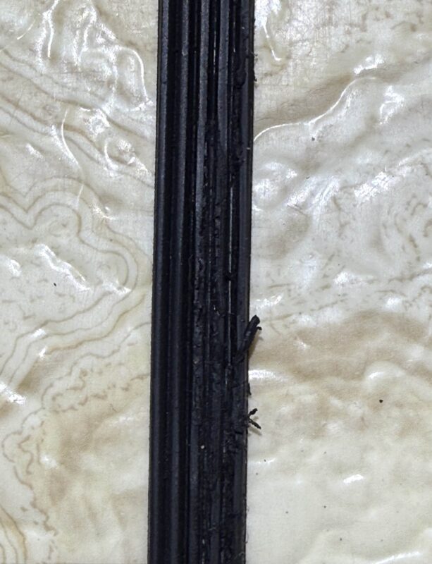 Damaged Belt – Grooves for the pulley are partially missing.