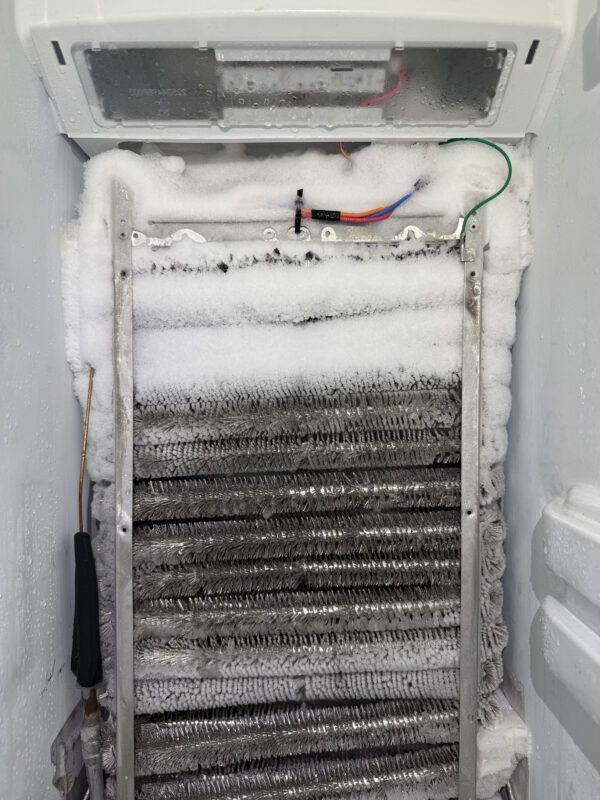 Closer view of the evaporator: There’s a lot of frost buildup. The fan motor was clogged and not spinning, which caused the loss of cold airflow.