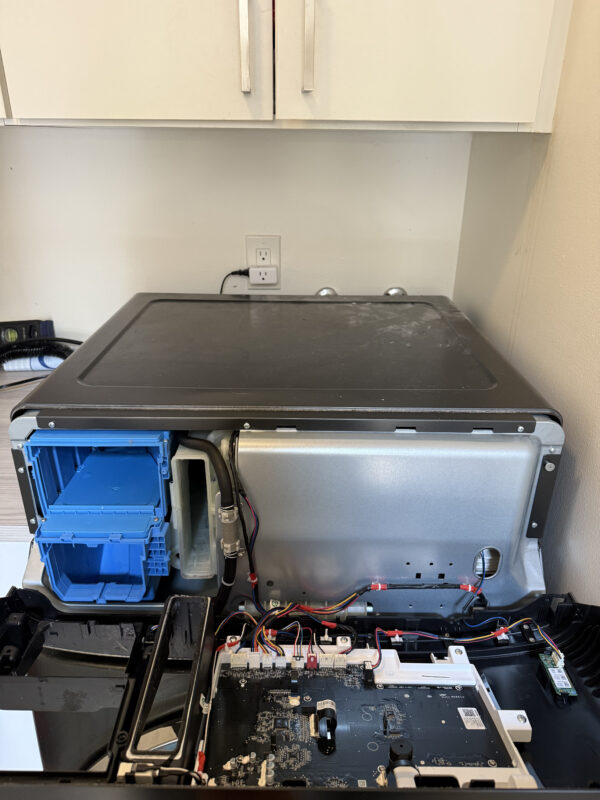 Remove screws near the dispenser, then pull the panel right and out.