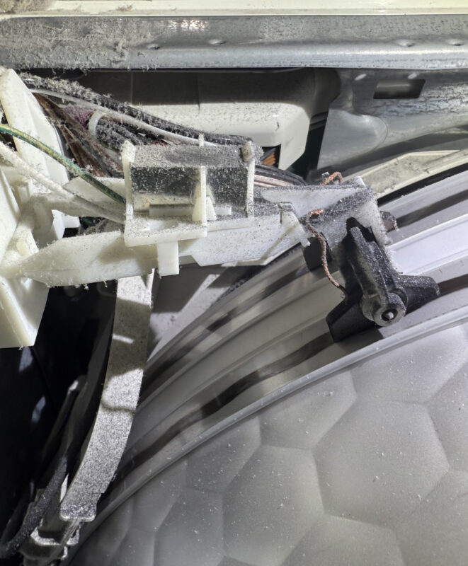 Behind the wires is part of the control board—gently press it down.