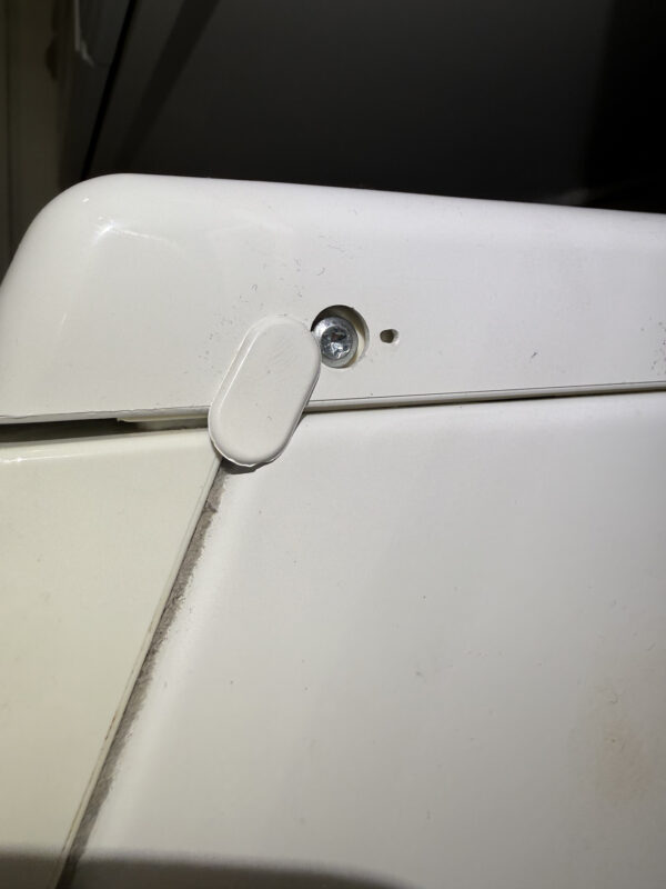 Pop off the cover and remove the screw on both sides.