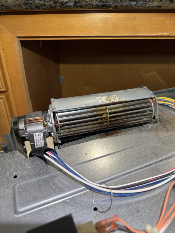 The blower is seated in the housing, but it needs to be carefully unscrewed.