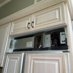 Refrigerator before repair, control panel removed