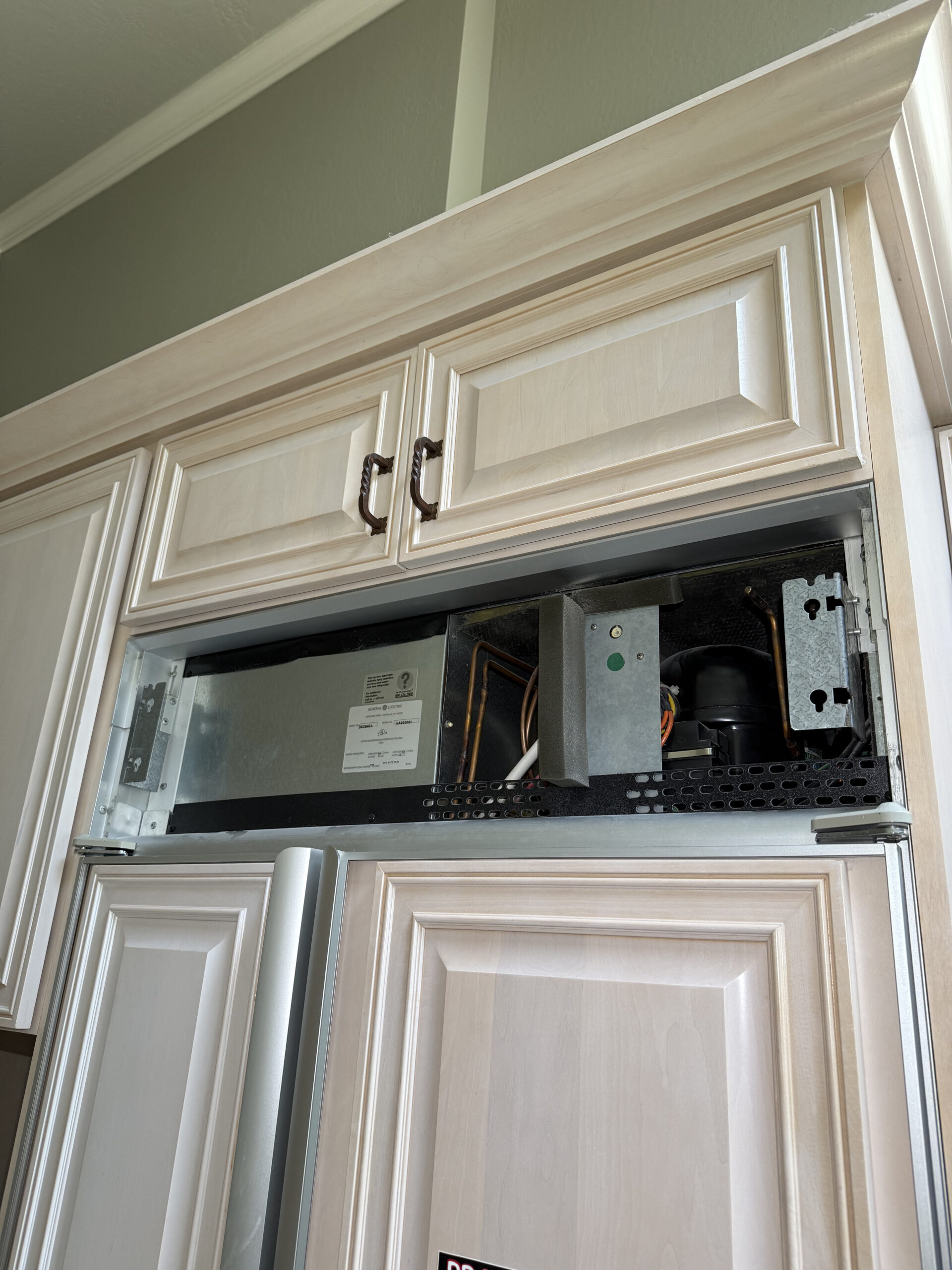 Refrigerator before repair, control panel removed